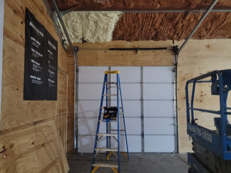 Residential garage door installation with track work in progress